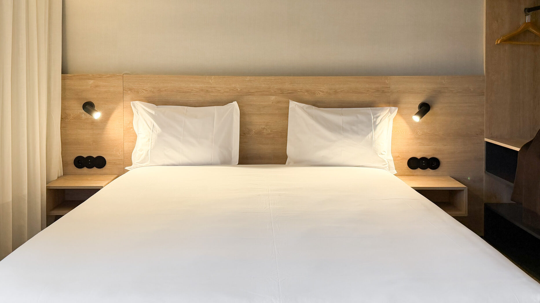 Large double bed inside apartment in Porto.