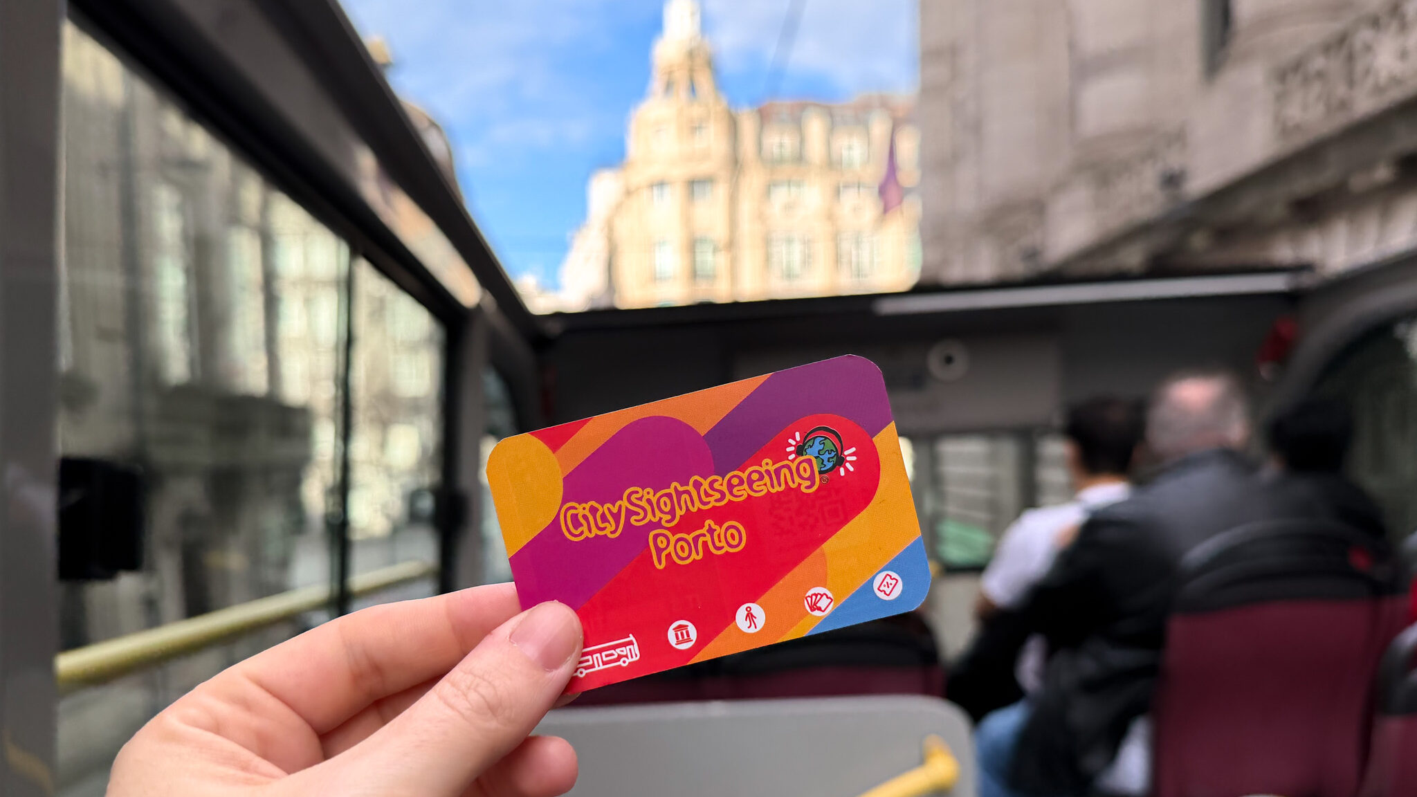 Bus card held up on upper deck of bus.