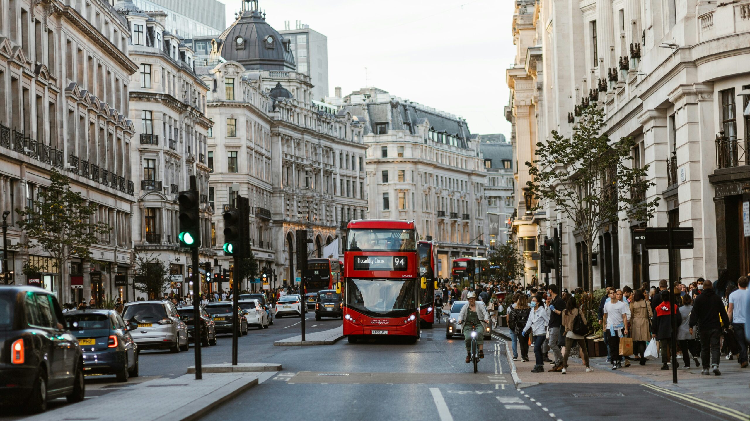 View of street in London with red bus.