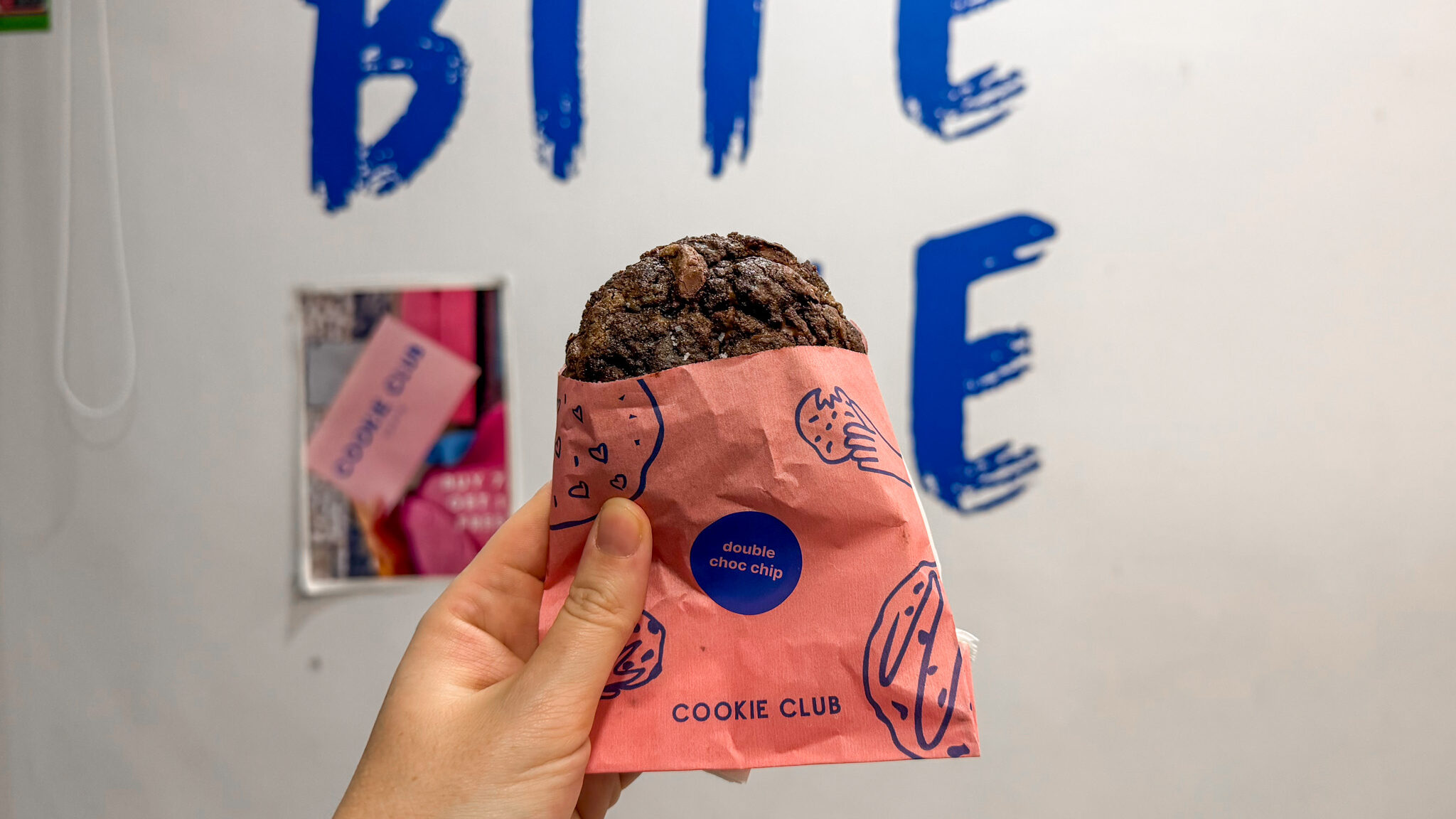 Double chocolate chip cookie in pink paper.