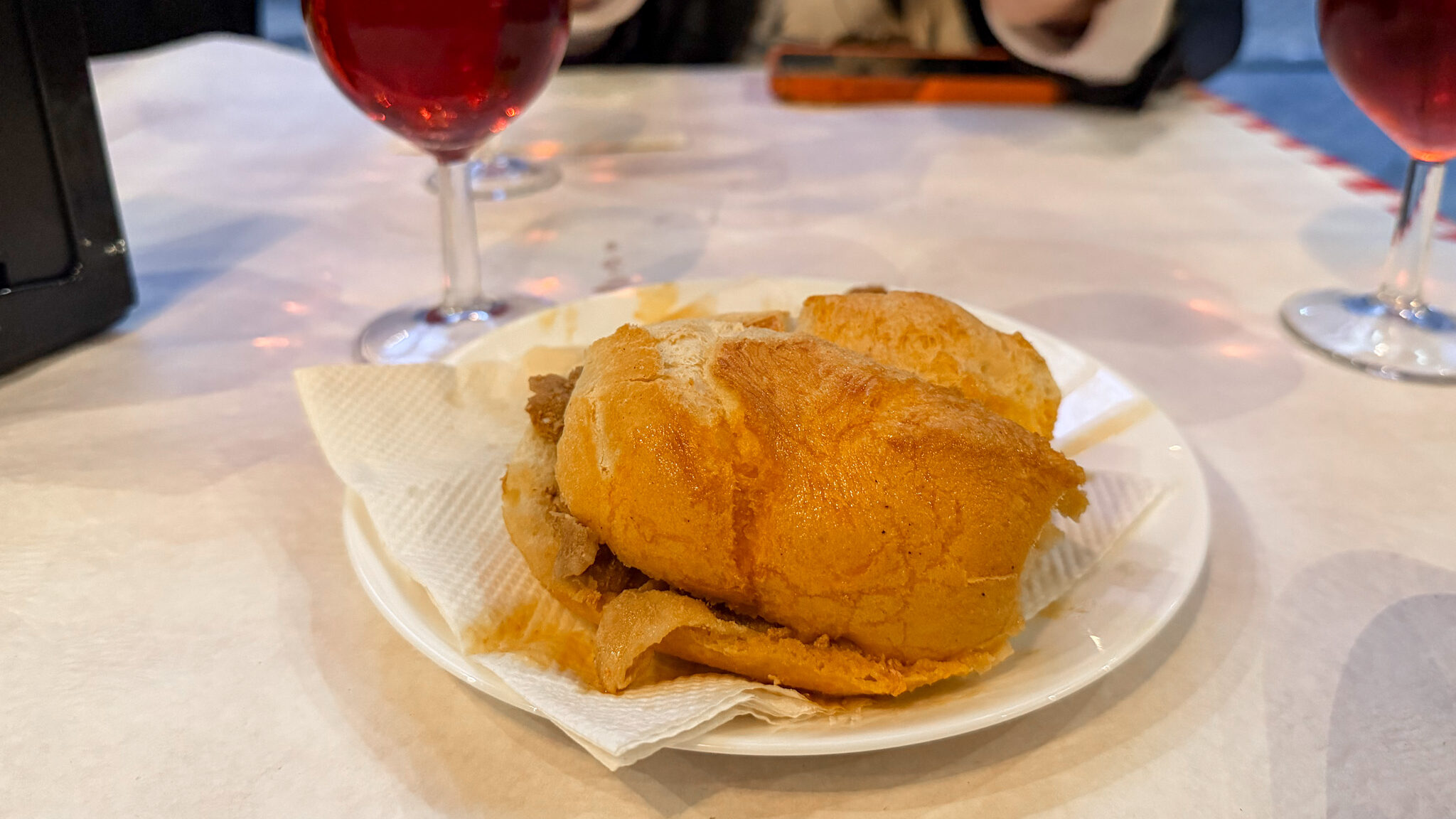 Portuguese pork sandwich with red wine.