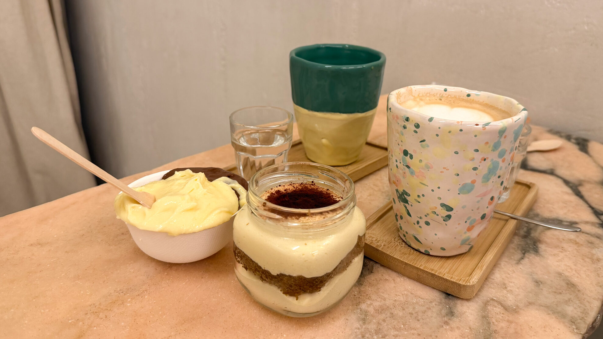 Traditional tiramisu on table with coffee and gelato.