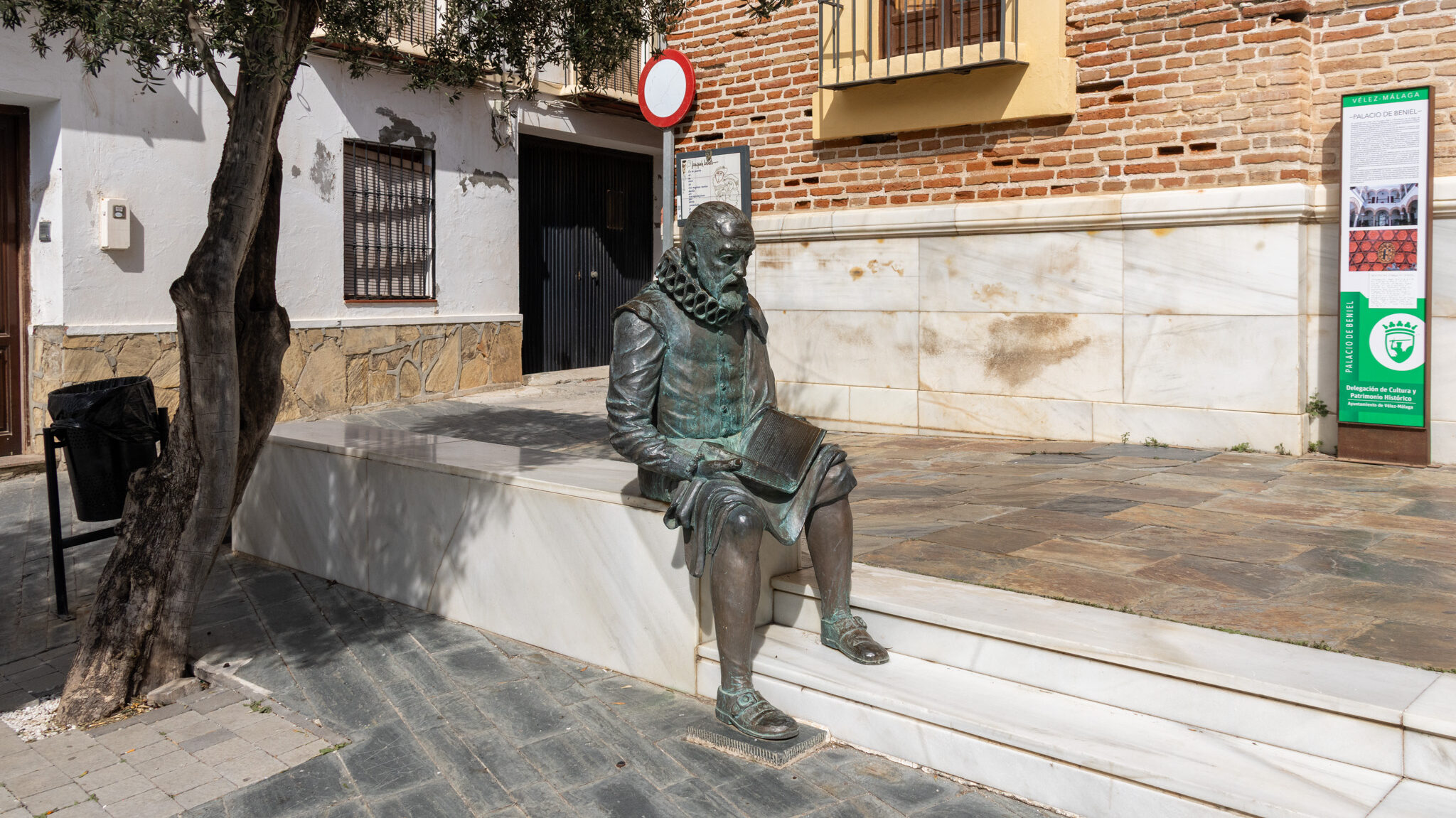 Cervantes Velez Malaga | Krista the Explorer Statue of Cervantes sitting outside palace.