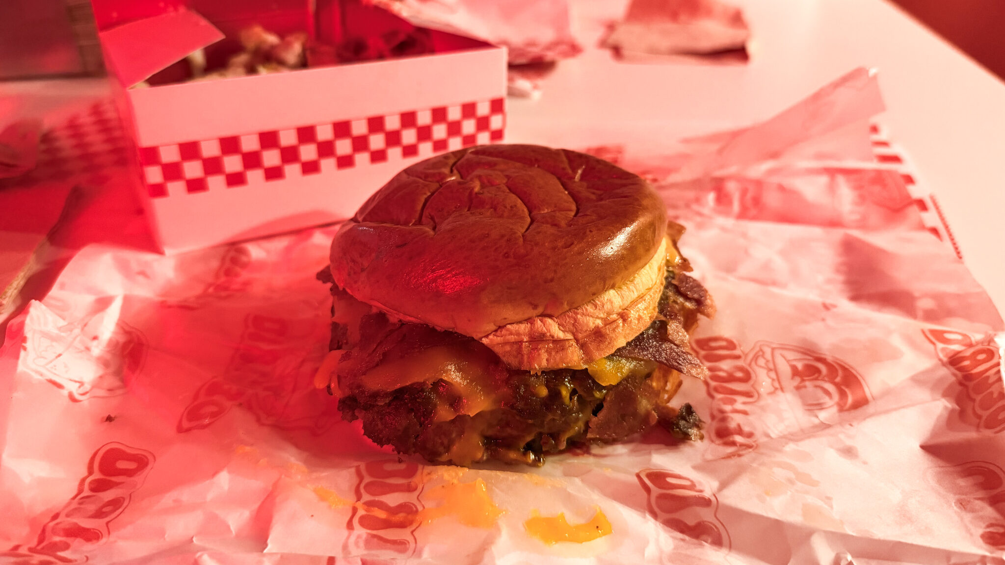 Smash burger served in parchment paper.