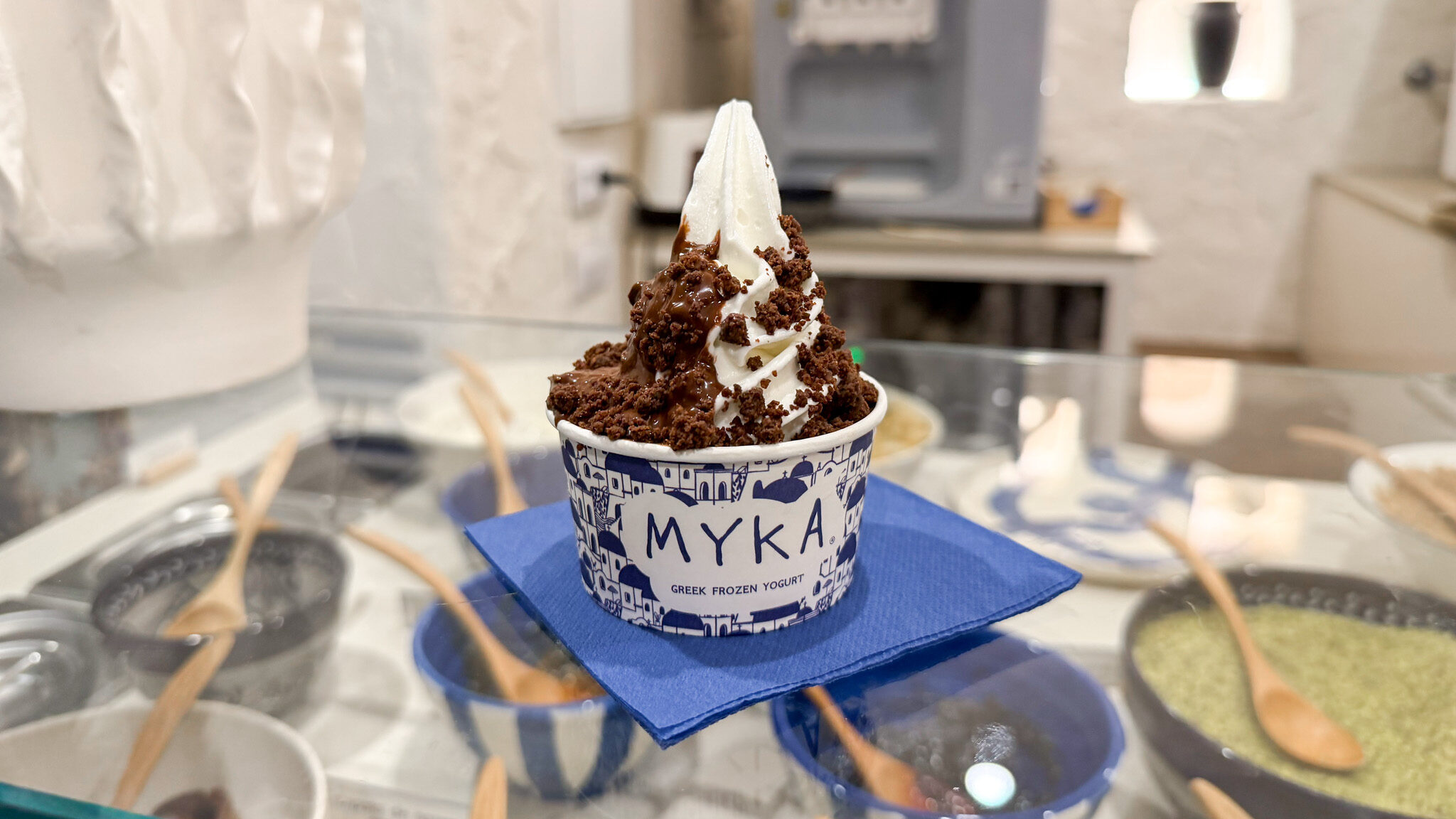 Greek frozen yogurt topped with chocolate toppings.