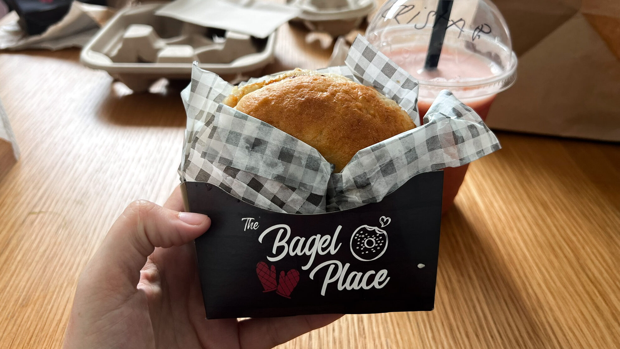 Breakfast bagel delivered in black paper box.