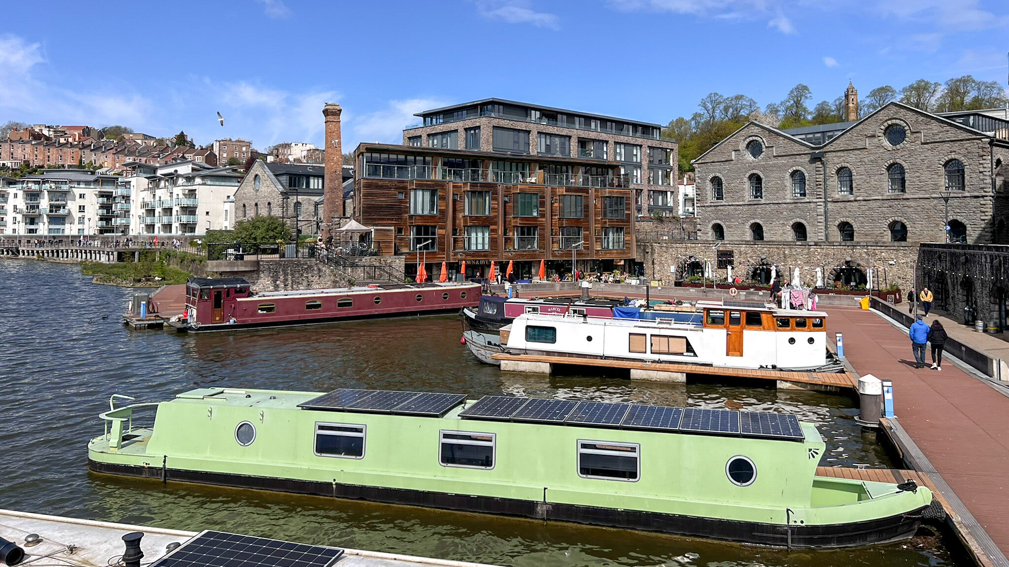Quay in Bristol with canal boats docked.