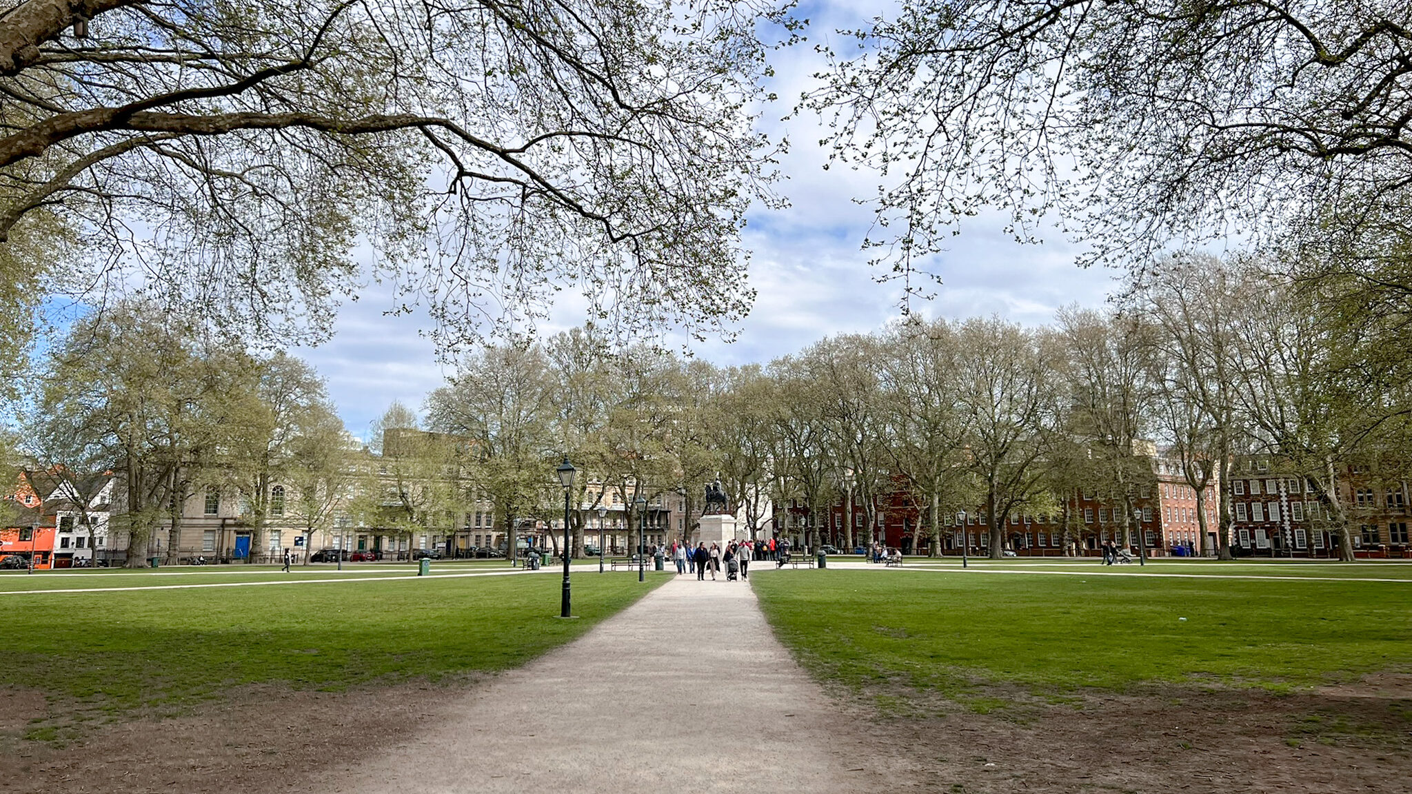 Large green space with statue in the centre.