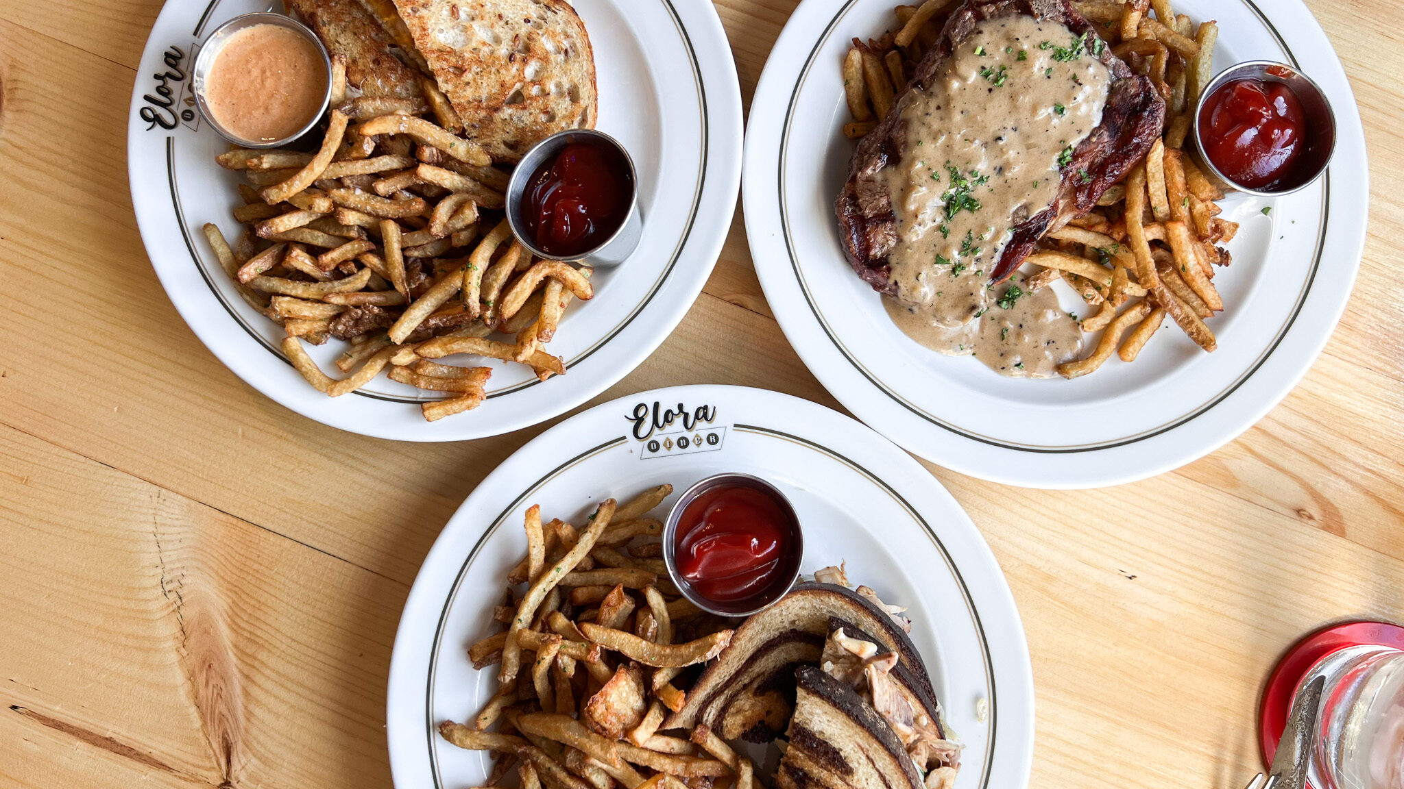 Three lunch dishes at retro themed restaurant.