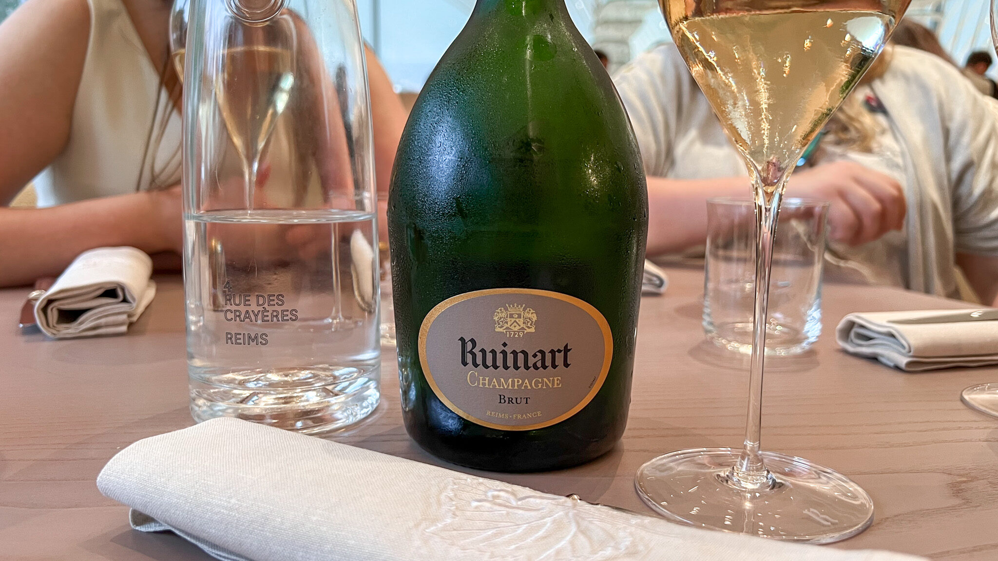 Bottle of Champagne on table in bar.