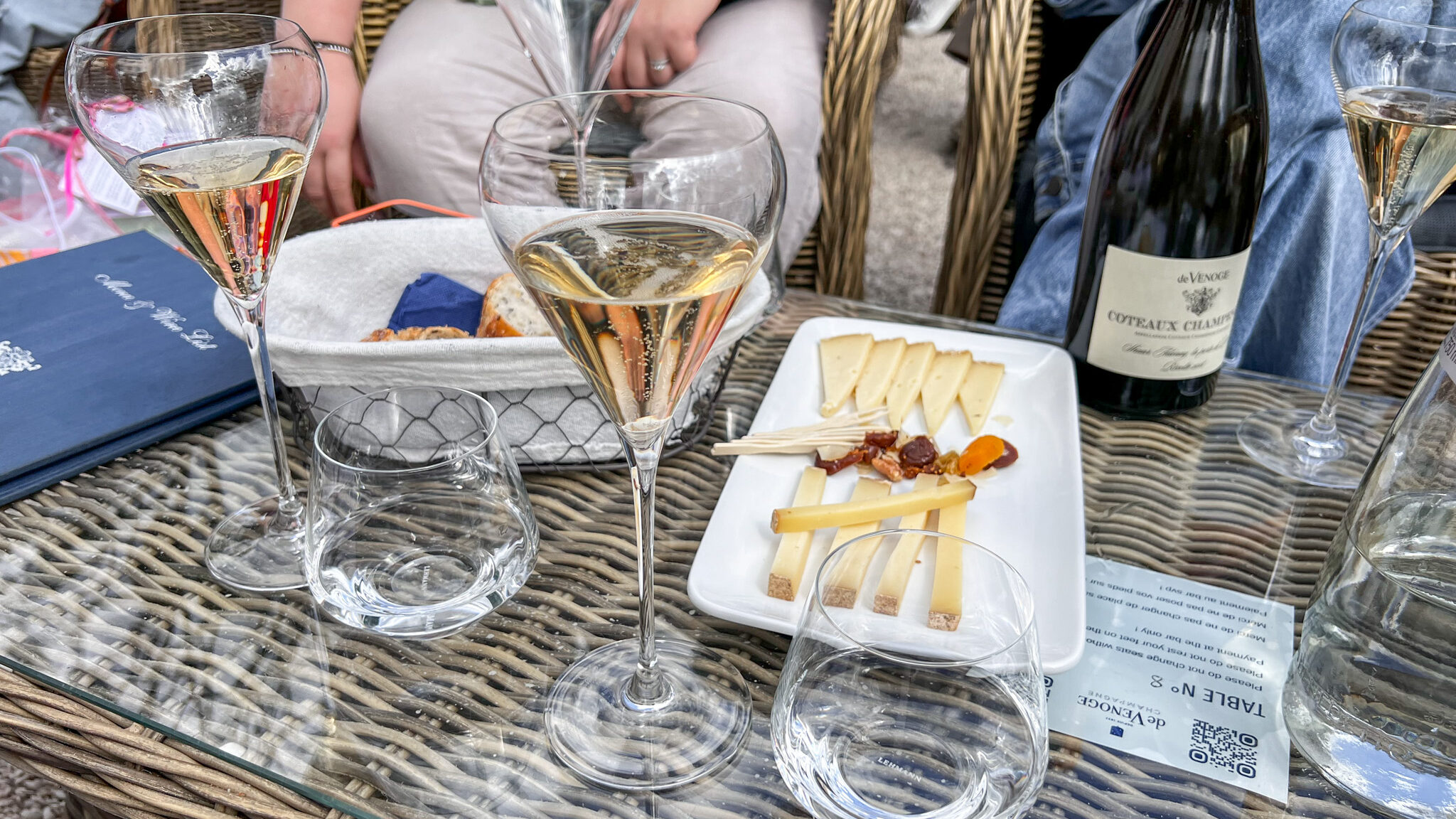 Champagne glasses on table with nibbles.