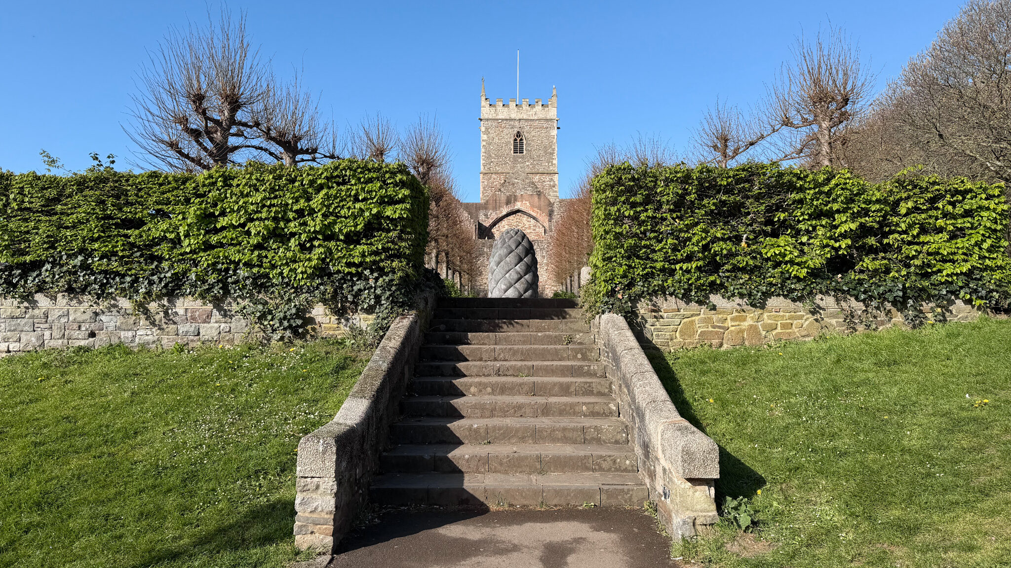 Stone staircase with low walls leading up to a crenellated stone tower.