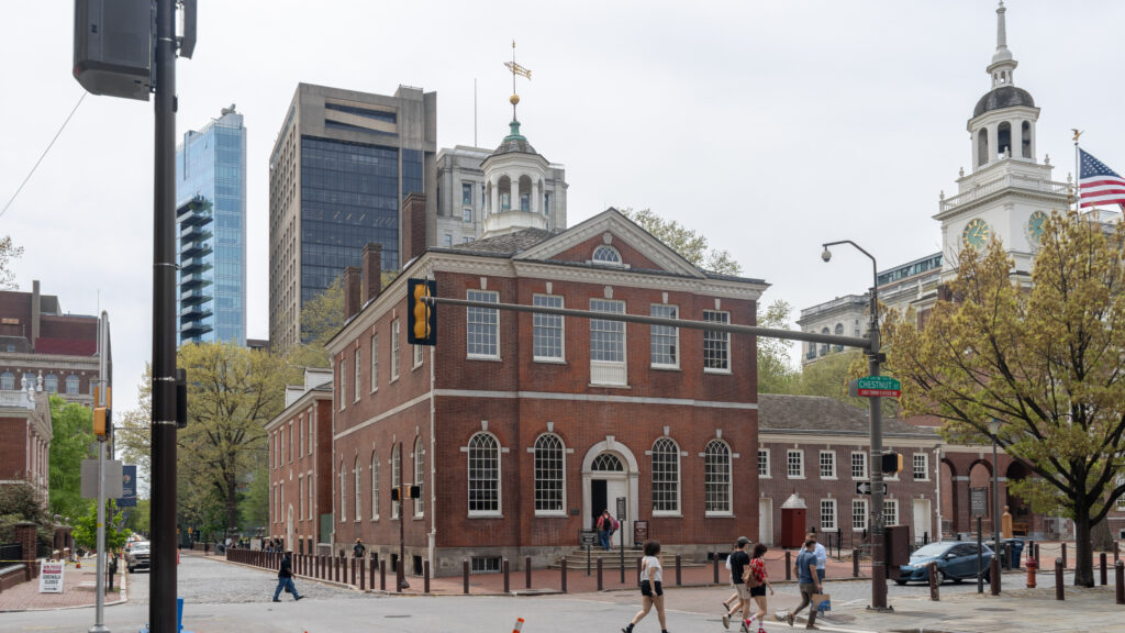 Historic red-brick courthouse on a city street with pedestrians.