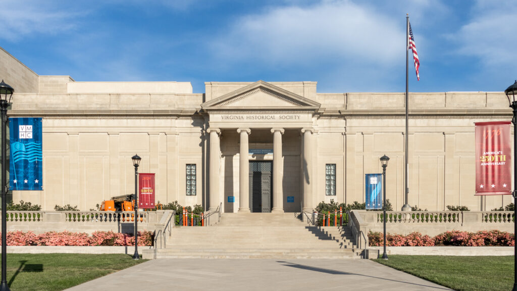 Museum with columns at entrance and grand stairs in front.