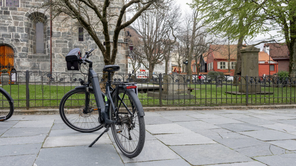 Electric bike parked in front of church in Bergen.
