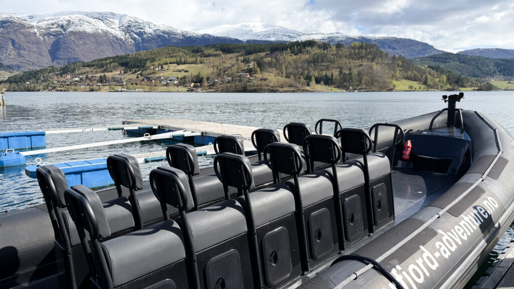 Inflatable tour boat parked at dock in Hardangerfjord.