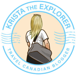 Circular logo for Krista the Explorer travel blogger, showing a blonde person with a backpack seen from behind, with light blue circular border text.