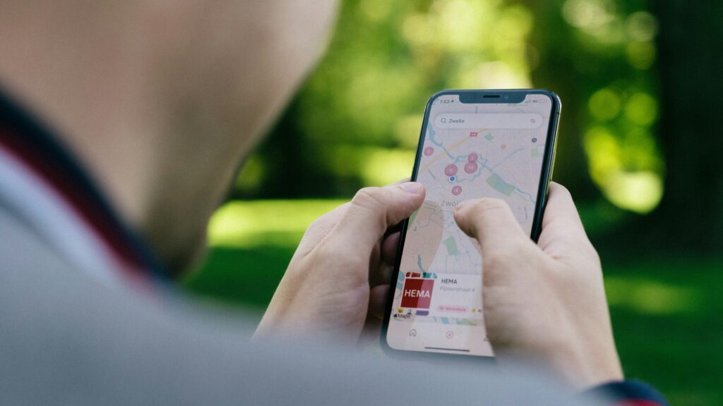 Phone Security | Krista the Explorer Man looking at directions on smartphone while in park.