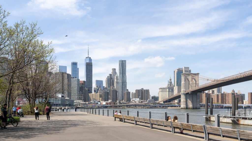 Brooklyn Bridge Park | Krista the Explorer View of Brooklyn Bridge from a small park next to water.