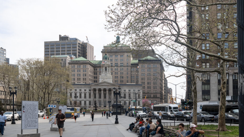 Columbus Park Brooklyn | Krista the Explorer City plaza with a large classical building featuring a green domed cupola and surrounding modern high-rises.