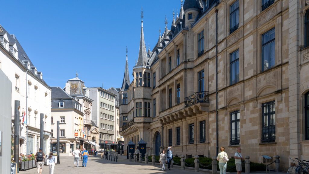Grand Ducal Palace Luxembourg | Krista the Explorer Street in a historic European city with ornate beige stone buildings.