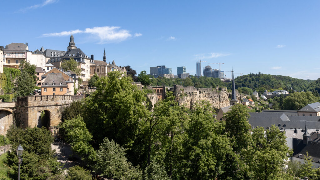 Corniche Luxembourg | Krista the Explorer Panoramic view of a historic town with stone fortress walls and river.