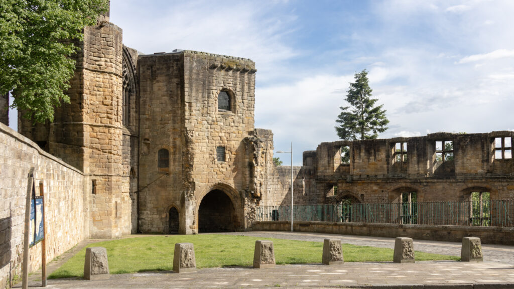 St Catherine's Wynd Dunfermline | Krista the Explorer Ruined stone fortress with arched doorways on road.
