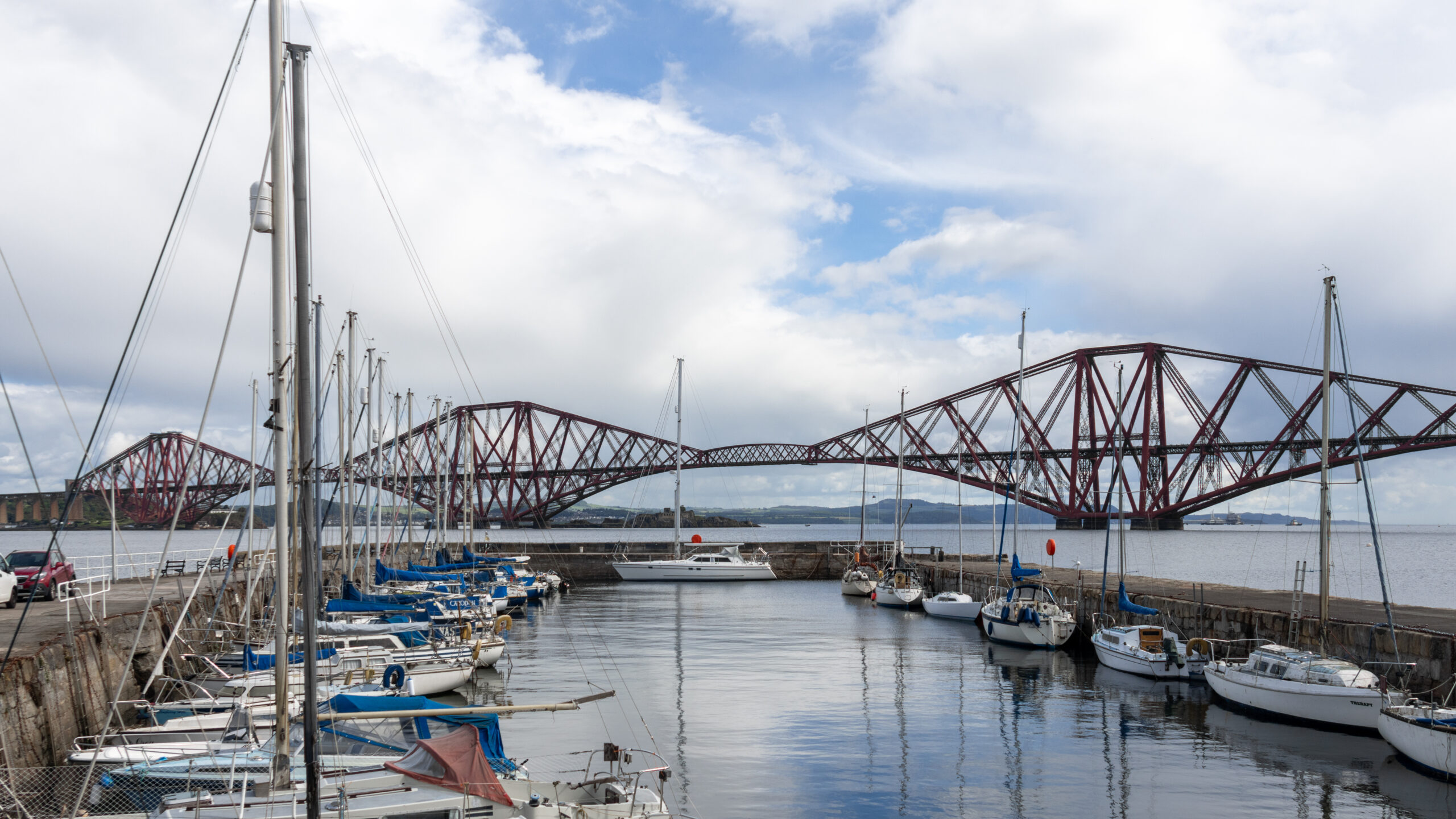 View of steel rail bridge with harbour in front.