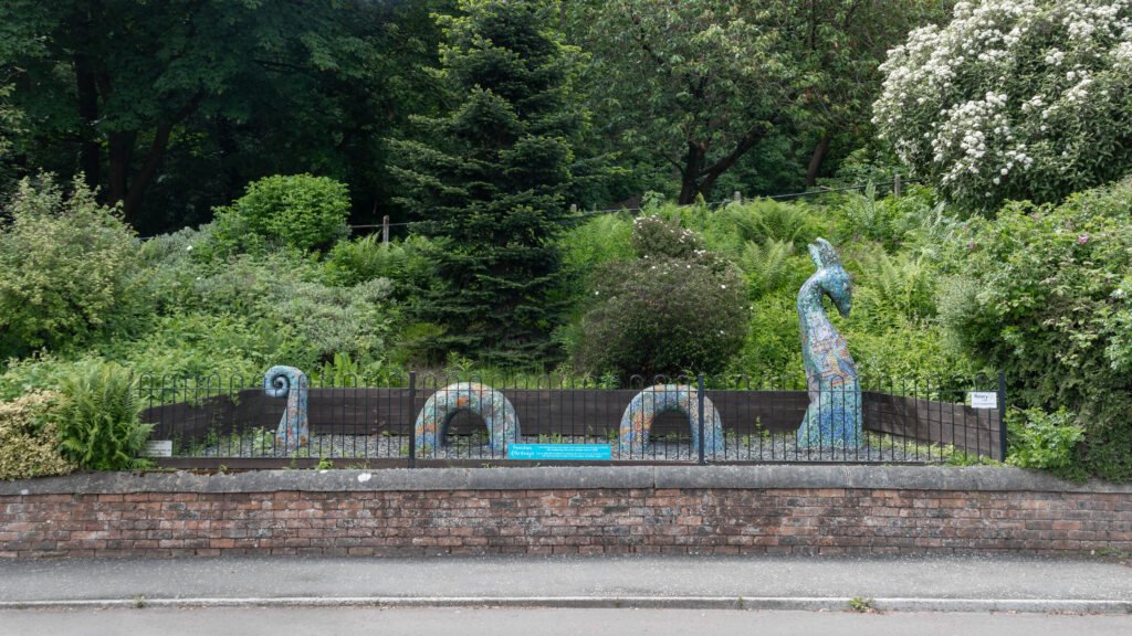 Sea serpent made out of mosaic tiles.