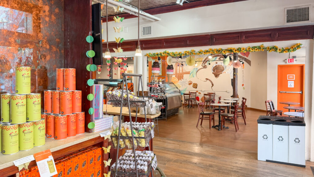 Jacques Torres Chocolate Brooklyn | Krista the Explorer Colorful chocolate shop interior with stacked orange and yellow tins.