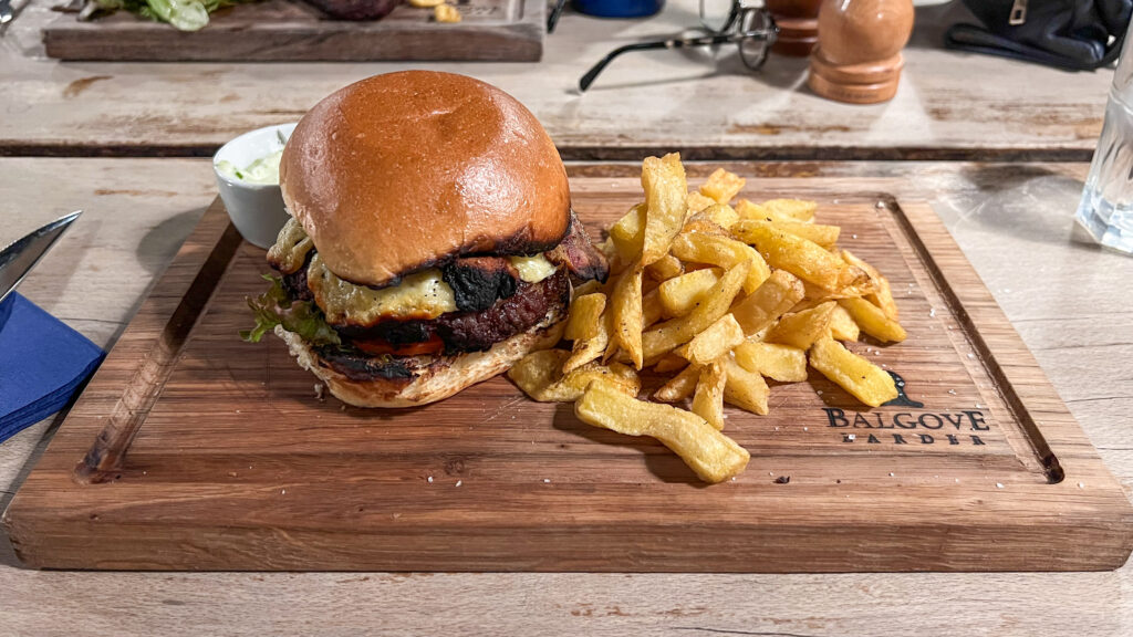 Juicy cheeseburger with lettuce and tomato on a toasted bun.