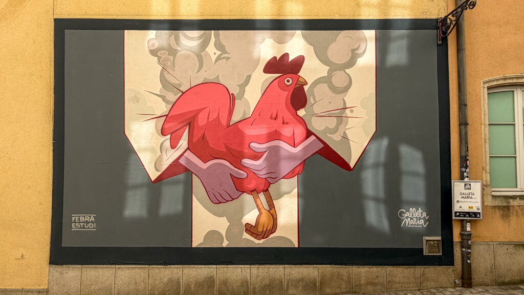 Street Art Luxembourg | Krista the Explorer Large pink rooster mural on a beige background.