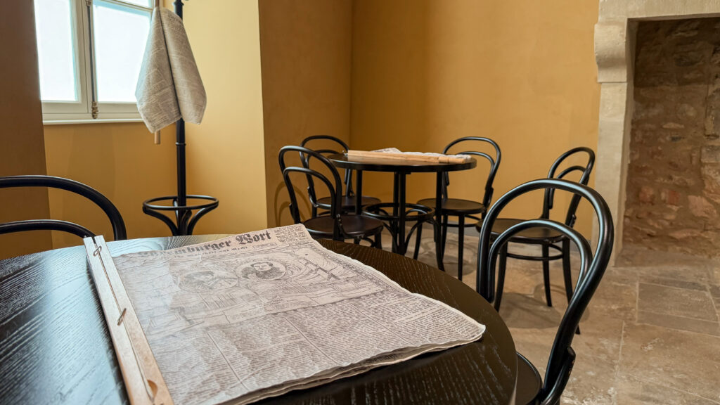 Museum Luxembourg | Krista the Explorer Interior of museum in Luxmembourg with old room and newspaper on table.