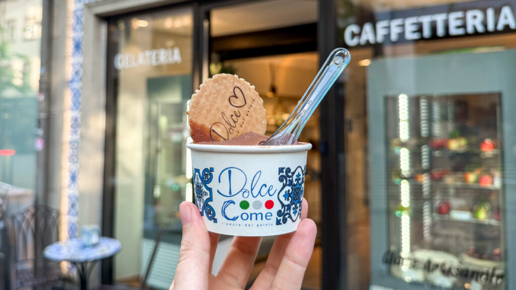 Dolce Gelateria Luxembourg | Krista the Explorer Person holding a cup of gelato with a wafer cookie.