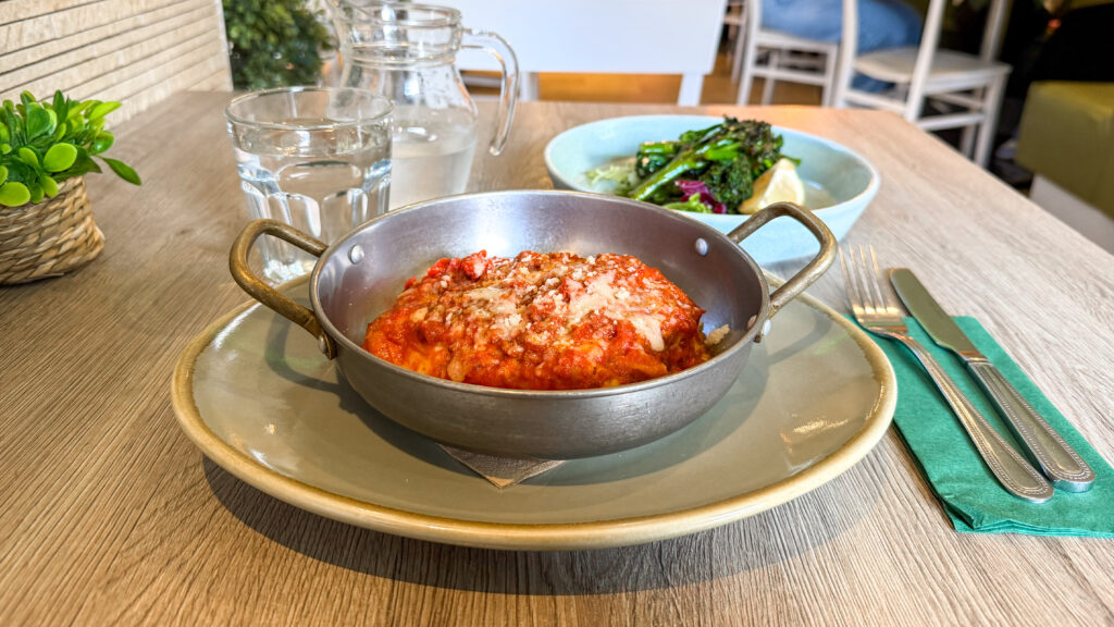 Casa Mia Dunfermline | Krista the Explorer Metal bowl with lasagne inside and a side dish of broccoli.
