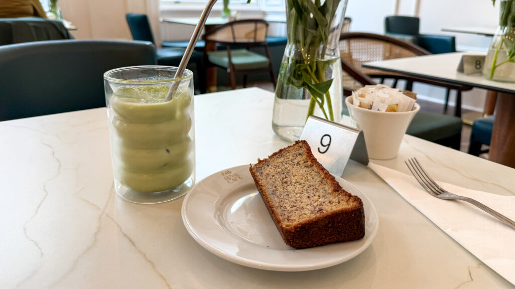 Little Royal Cafe Dunfermline | Krista the Explorer A glass of iced matcha latte with a slice of banana bread.
