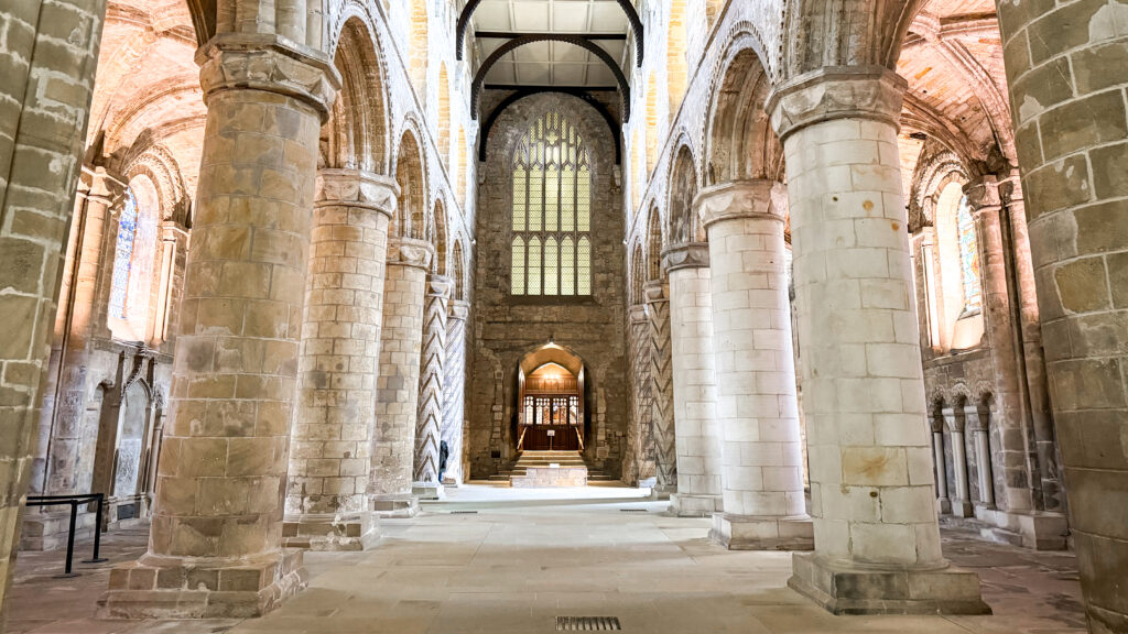 Dunfermline Abbey | Krista the Explorer Interior of a cathedral nave with tall stone columns.