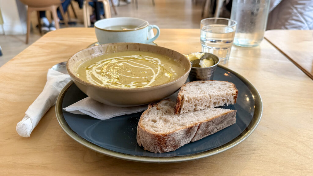 Wynd Dunfermline | Krista the Explorer Creamy soup in a rustic bowl with a swirl of cream, served with crusty bread.