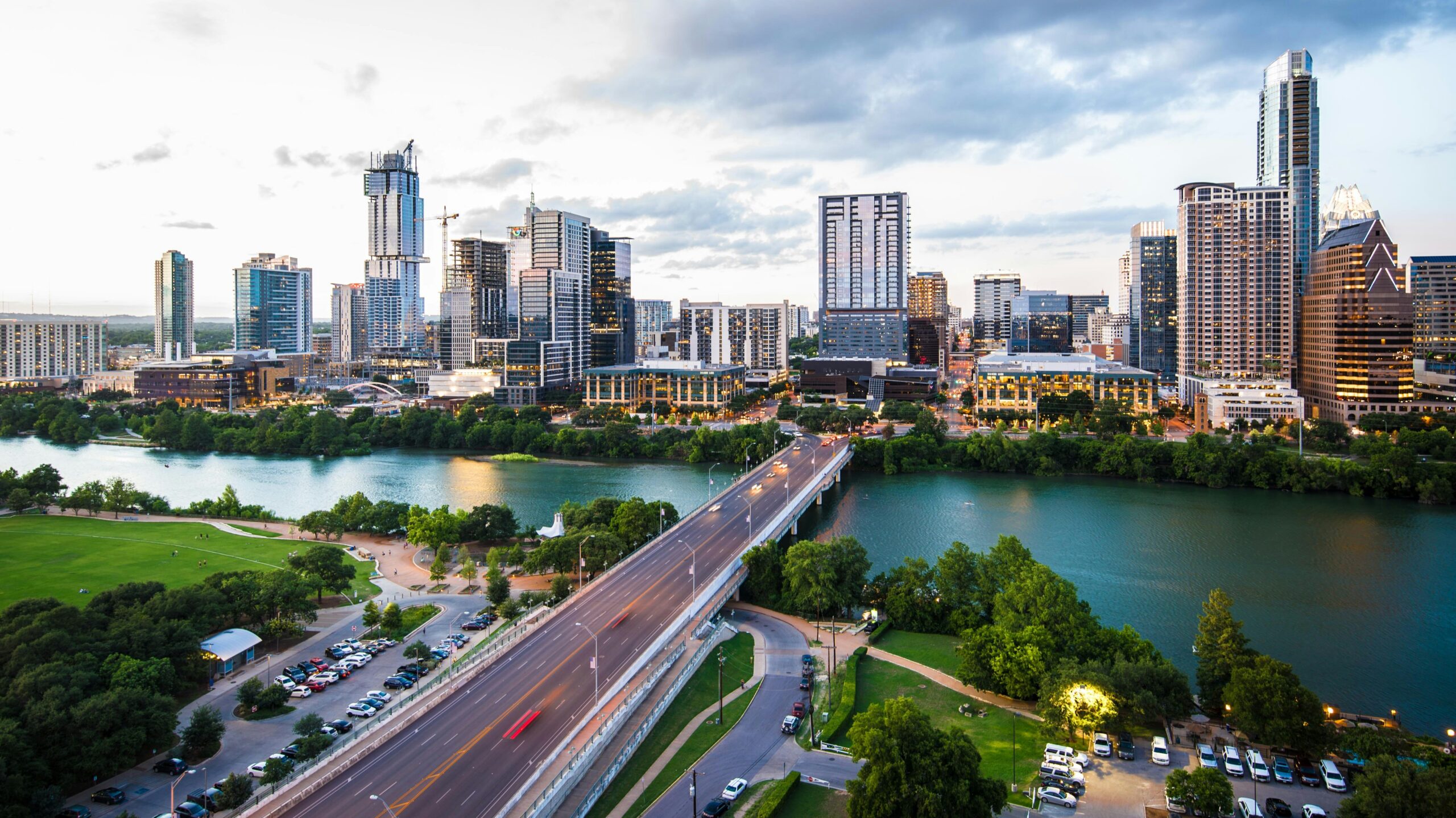 Wide view of a modern city skyline with tall glass buildings.
