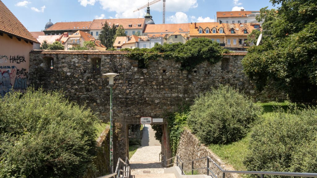 Bishop Duh Steps Zagreb | Krista the Explorer Remains of medieval fortress wall with historic buildings behind it.
