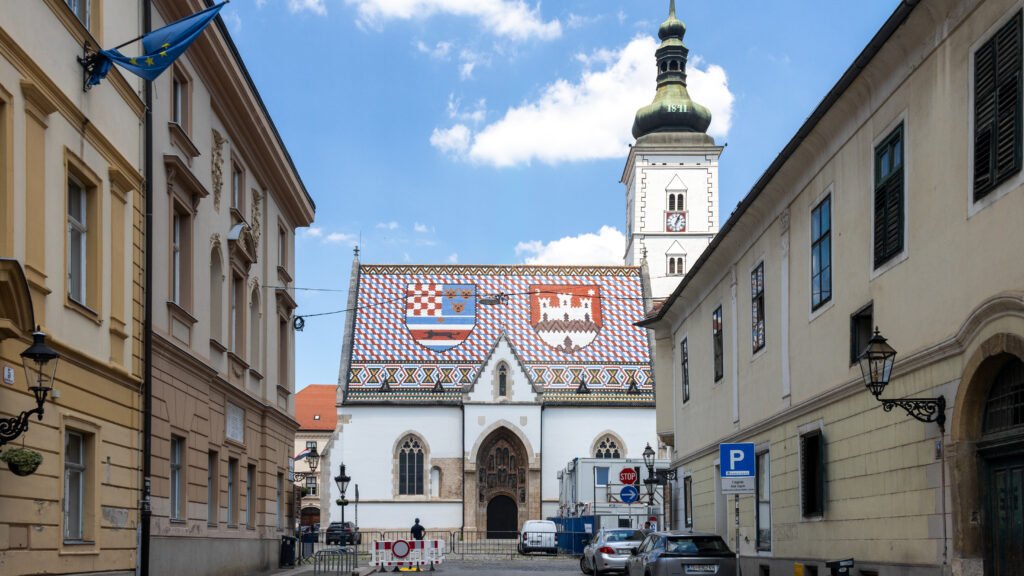 St Mark’s Church Zagreb | Krista the Explorer Narrow street leading up to church with colourful tiled roof.