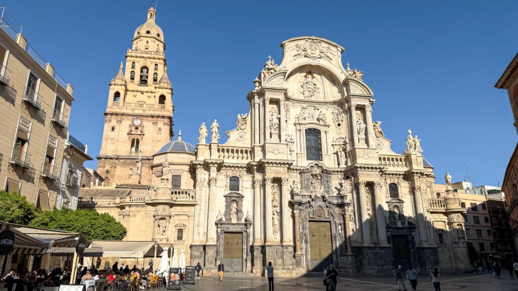 Murcia Cathedral with golden hour lighting on its towers.