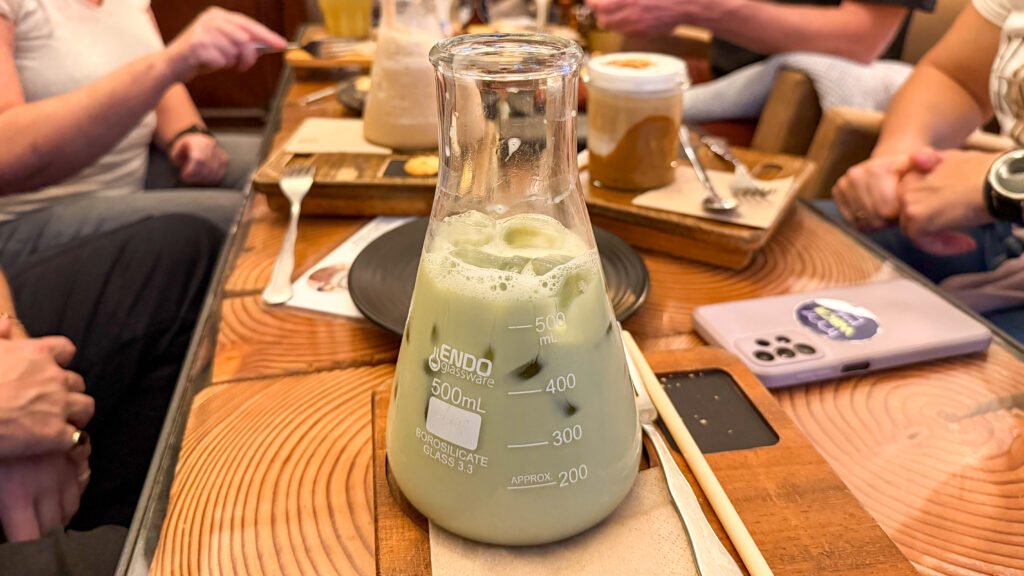 CafeLab Murcia | Krista the Explorer Iced matcha served in science glass in cafe.