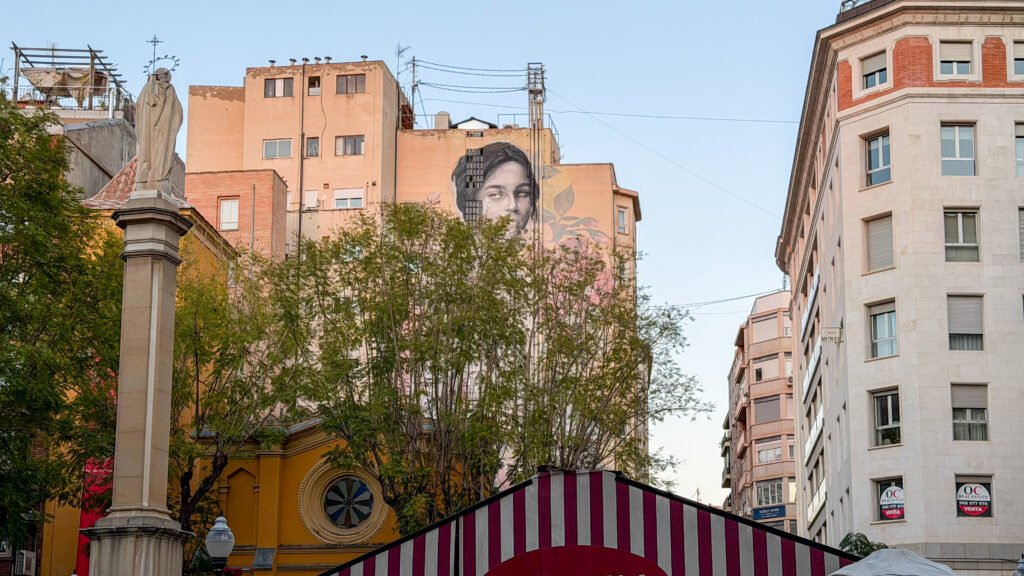 Street Art | Krista the Explorer Street art on side of building next to flower plaza.