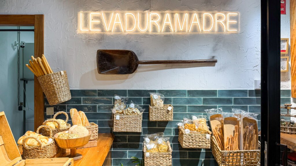 Levaduramadre Murcia | Krista the Explorer Bakery display with woven baskets of baguettes and loaves.