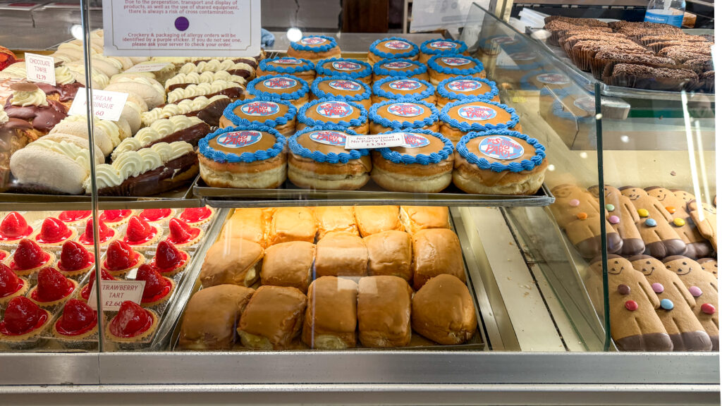 Bakery display with variety of doughnuts and baked goods.