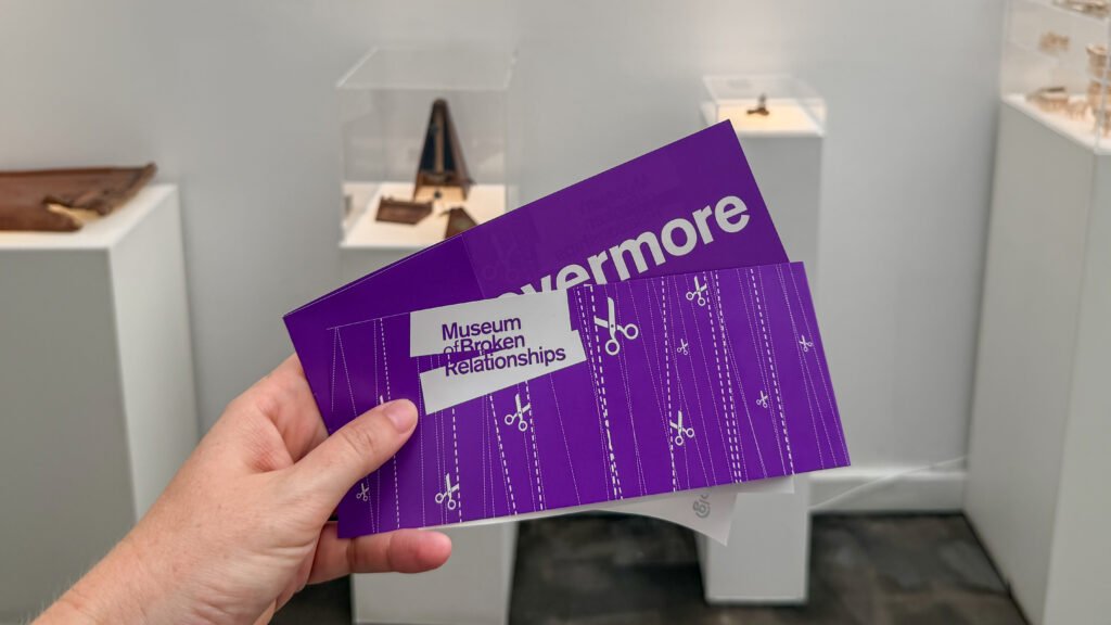 Museum of Broken Relationships Zagreb | Krista the Explorer Person holding a purple Museum of Broken Relationships ticket.