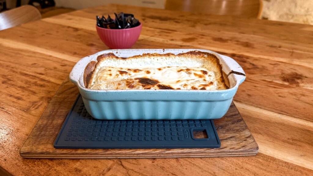 La Struk Zagreb | Krista the Explorer Blue ceramic casserole dish with a creamy strukli inside.