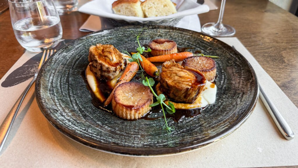 Fidel Gastro Zagreb | Krista the Explorer Plate with seared meat medallions, glazed carrots, potato rounds, and microgreens.