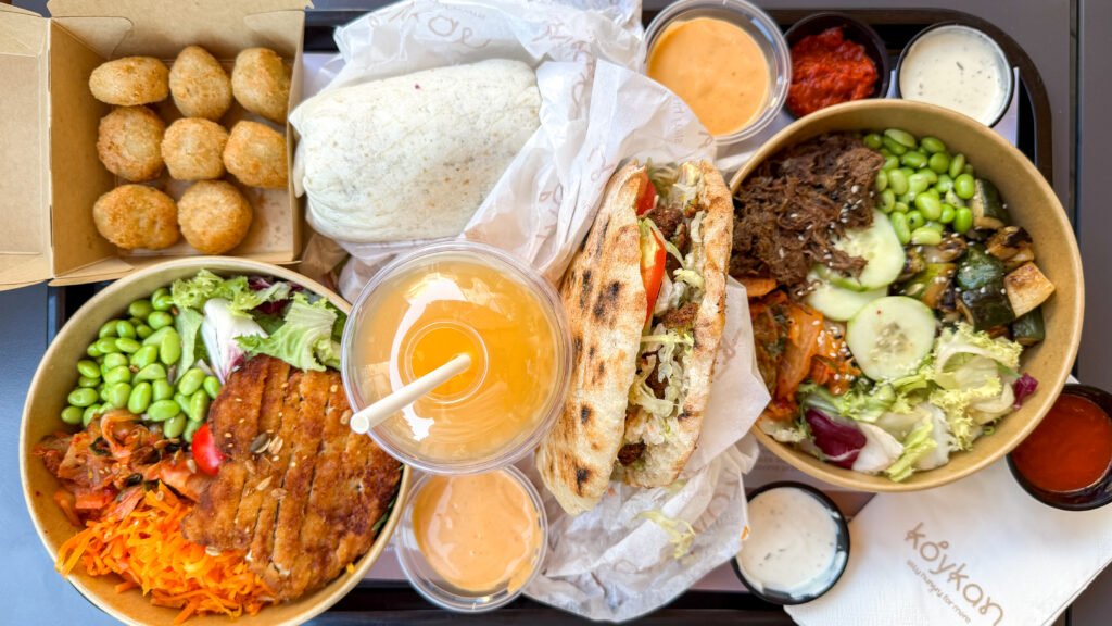 Koykan Zagreb | Krista the Explorer Assortment of rice bowls, falafel wrap, and fresh juice from restaurant.